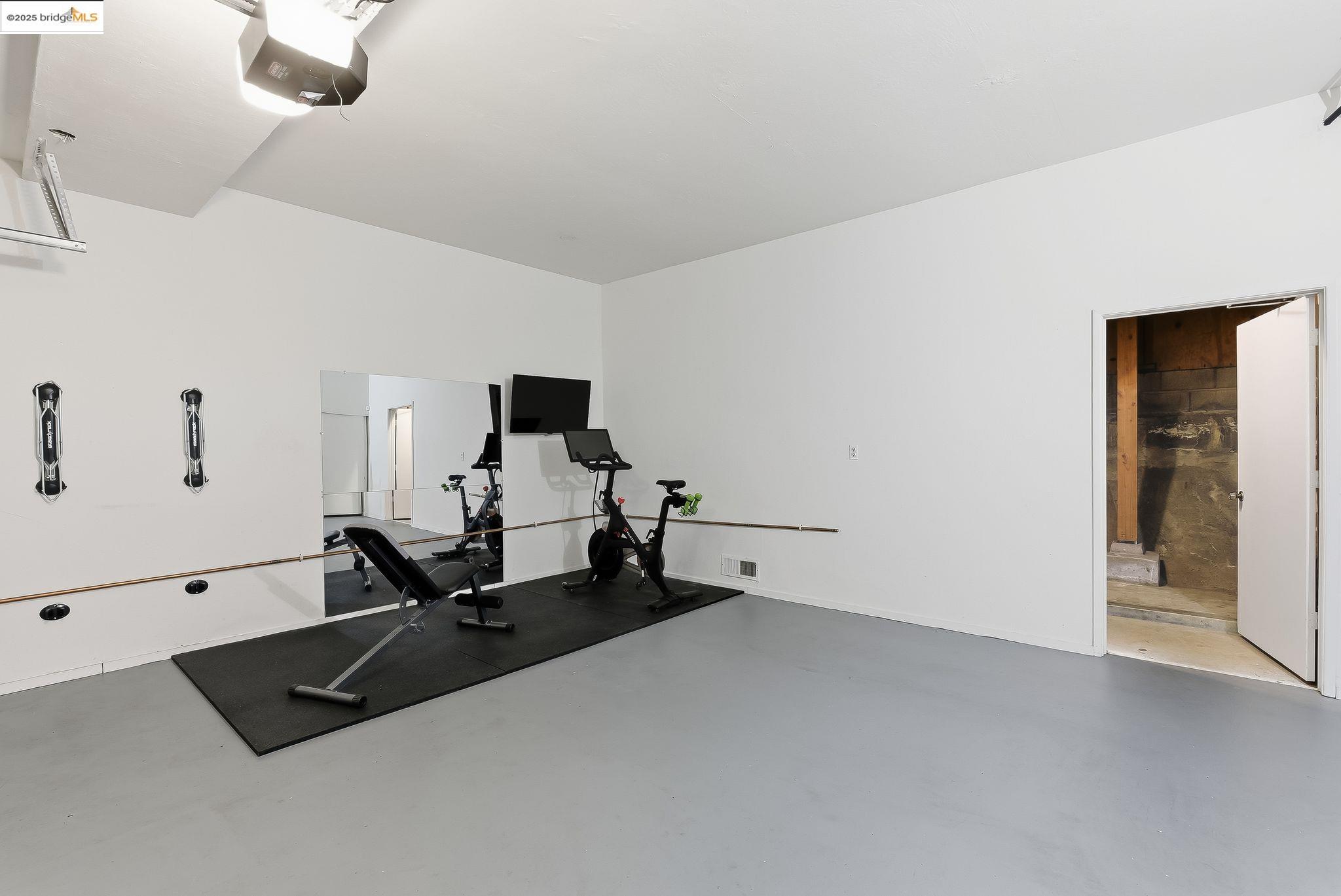 2 Sereno Circle Oakland, CA 94619 - Photo 34 of 42 a room with gym equipment and a view of living room