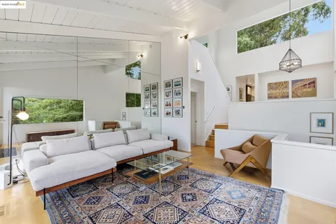 a living room with furniture rug and window