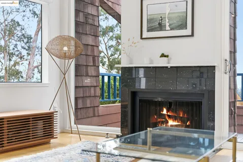 a living room with a fireplace and a chandelier