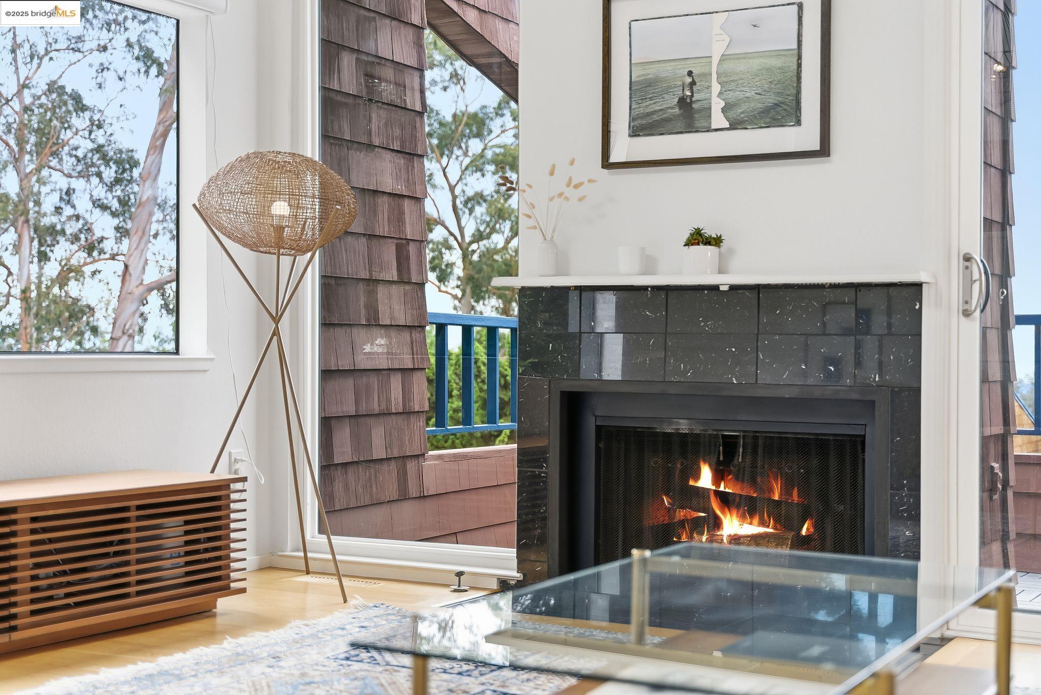 2 Sereno Circle Oakland, CA 94619 - Photo 9 of 42 a living room with a fireplace and a chandelier