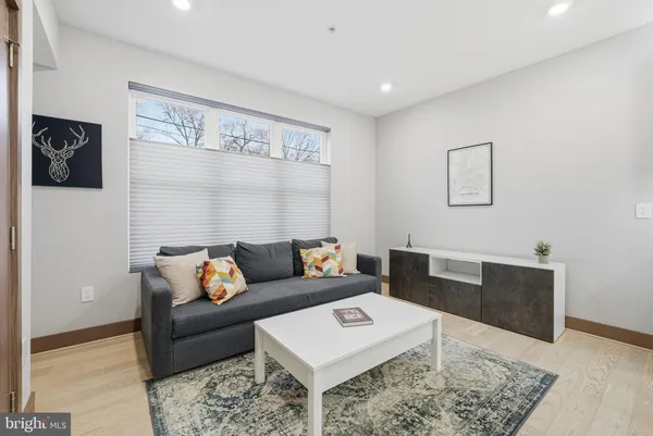 a living room with furniture and a rug