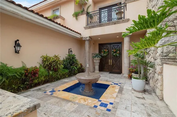 a view of a entryway of the house with potted plants