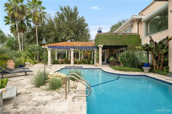 a view of a house with backyard porch and sitting area