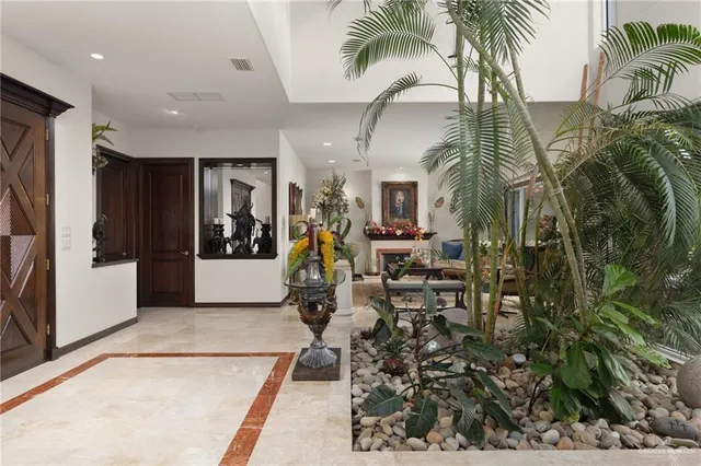 a very nice looking room with a large window and potted plants