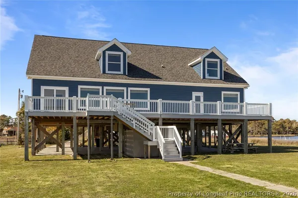 a kitchen with stainless steel appliances granite countertop a stove a refrigerator and a sink with wooden floors