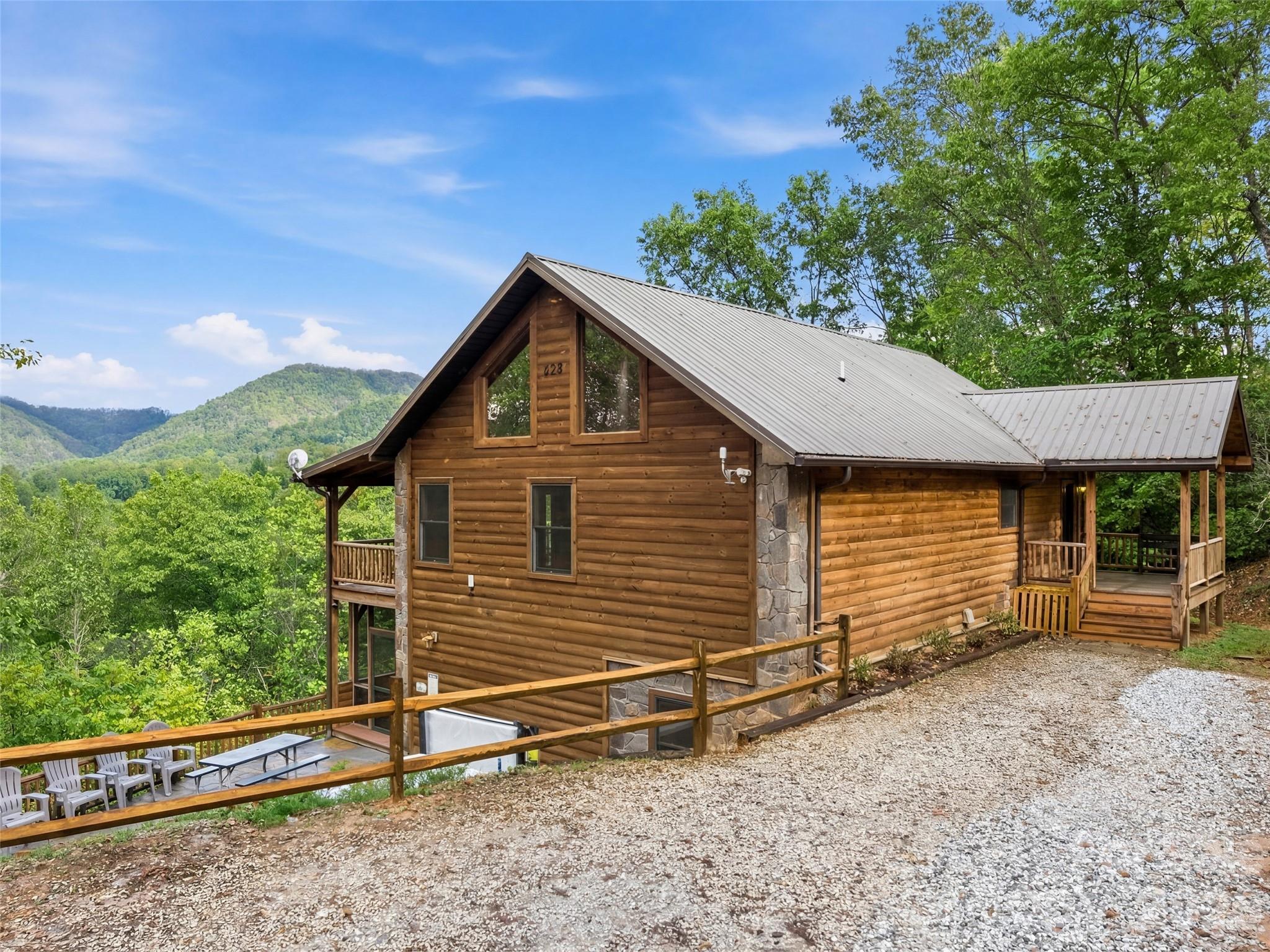 235 Soaring Eagle Road Bryson City, NC 28713 - Photo 4 of 42 a view of a house with a yard and wooden fence