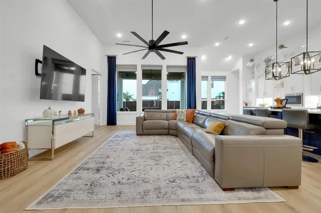 a living room with kitchen island furniture and a chandelier