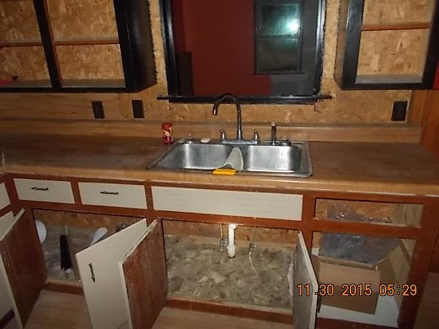 671 Tucker Road Lafayette, TN 37083 - Photo 17 of 20 a kitchen with a sink and a mirror