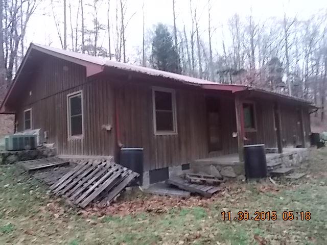 671 Tucker Road Lafayette, TN 37083 - Photo 3 of 20 a view of a house with backyard and trees