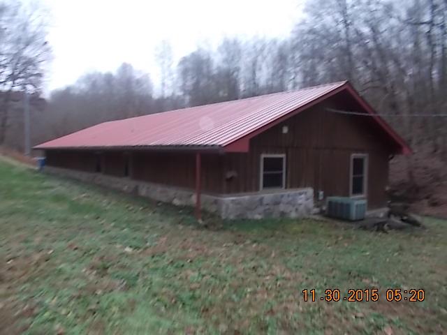 671 Tucker Road Lafayette, TN 37083 - Photo 6 of 20 a view of house with backyard and trees