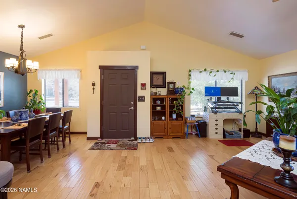 a view of a roof deck with table and chairs a barbeque with wooden floor and fence