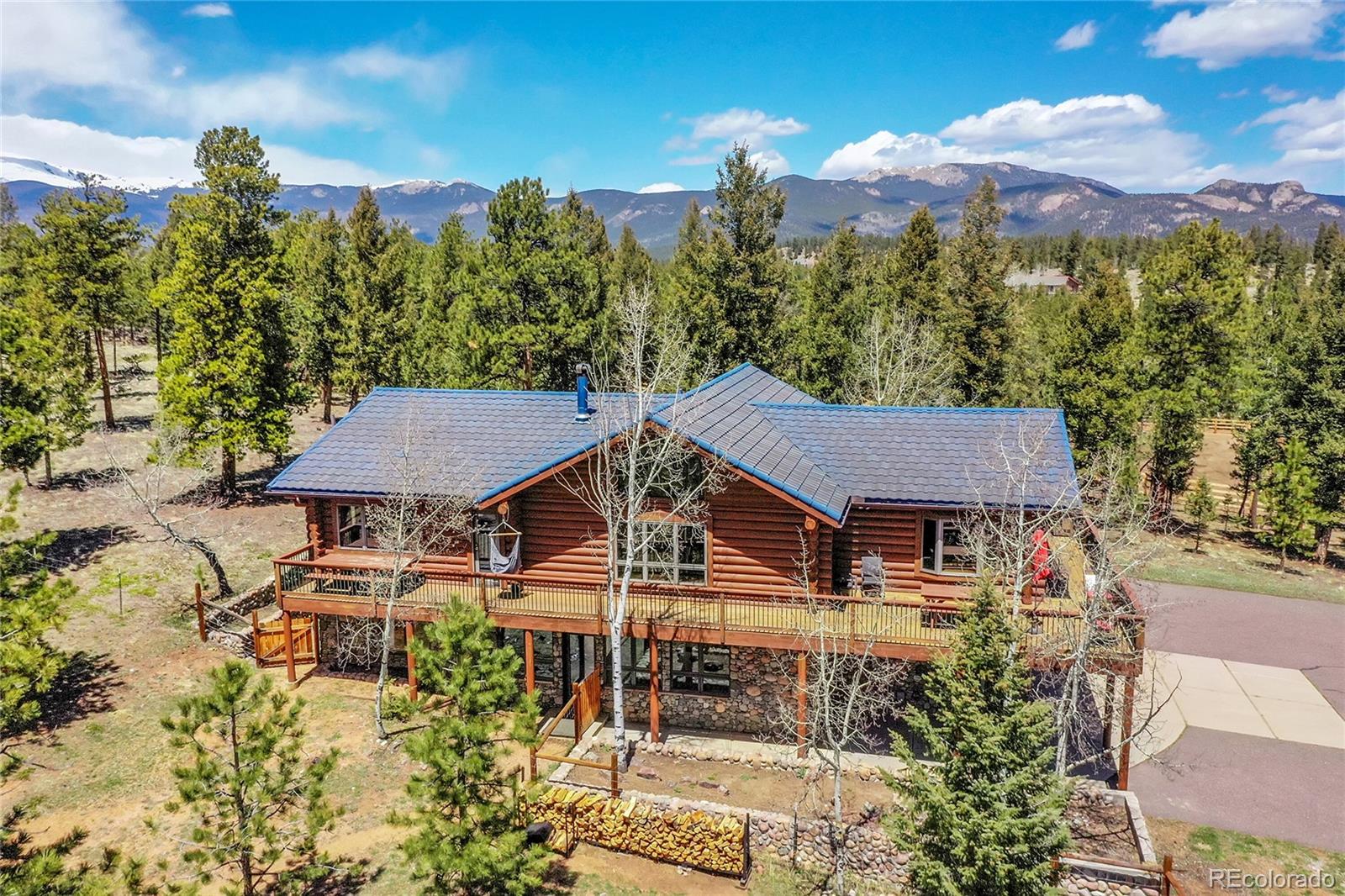 1392 Tapadero Road Bailey, CO 80421 - Photo 1 of 50 a aerial view of a house with a yard and a large tree
