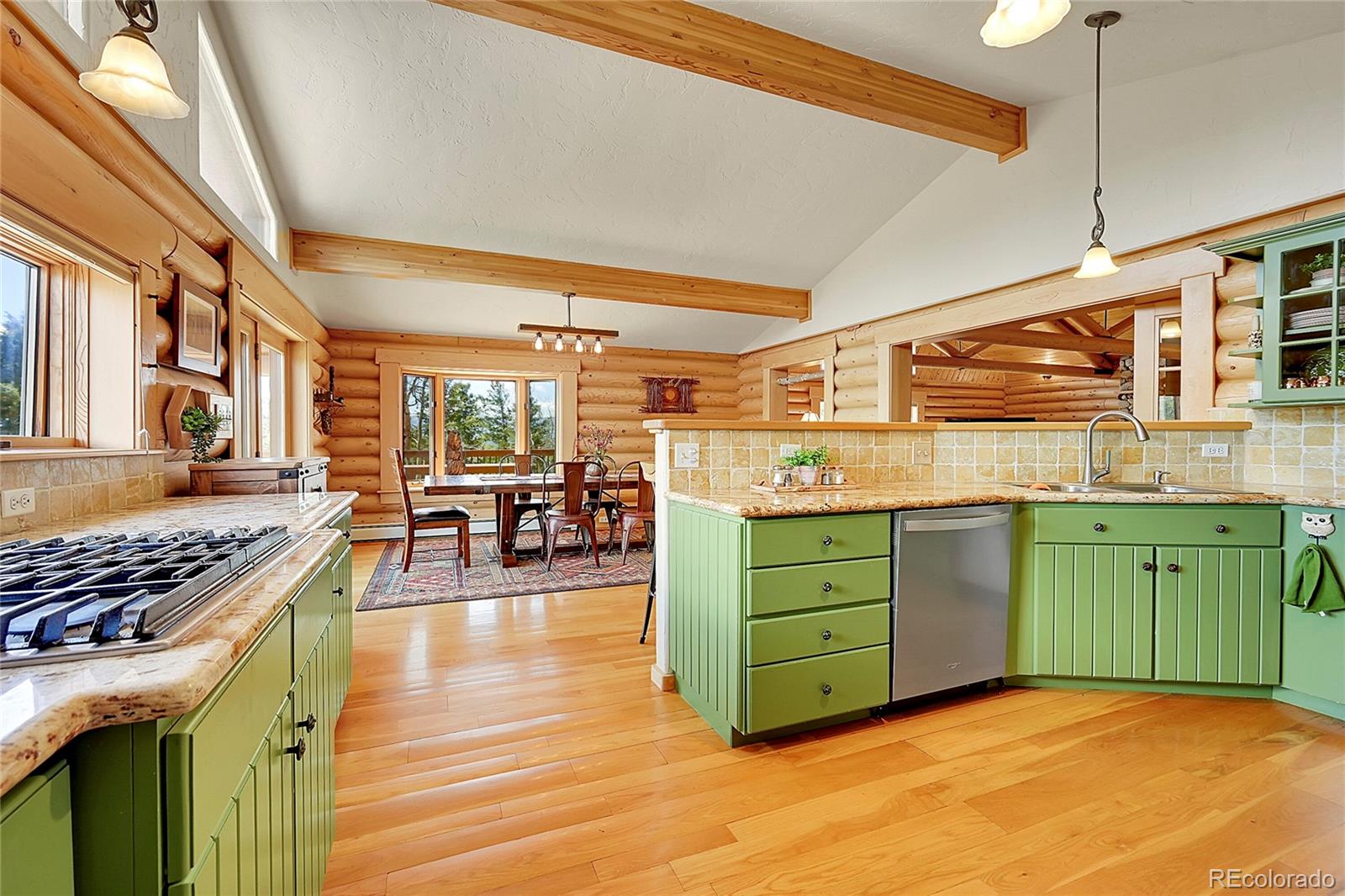 1392 Tapadero Road Bailey, CO 80421 - Photo 13 of 50 a kitchen with cabinets and chairs