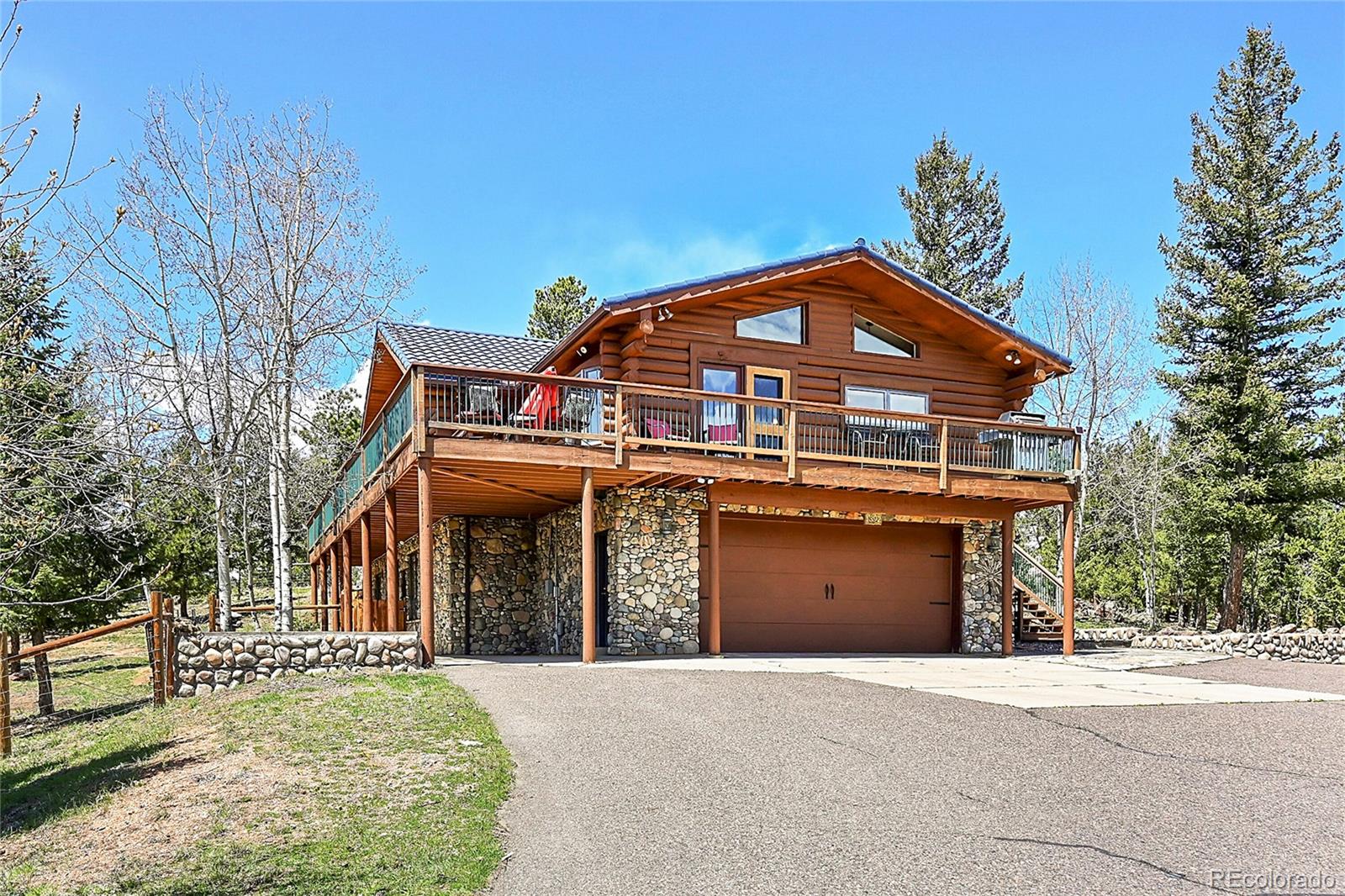 1392 Tapadero Road Bailey, CO 80421 - Photo 2 of 50 a front view of a house with a garden