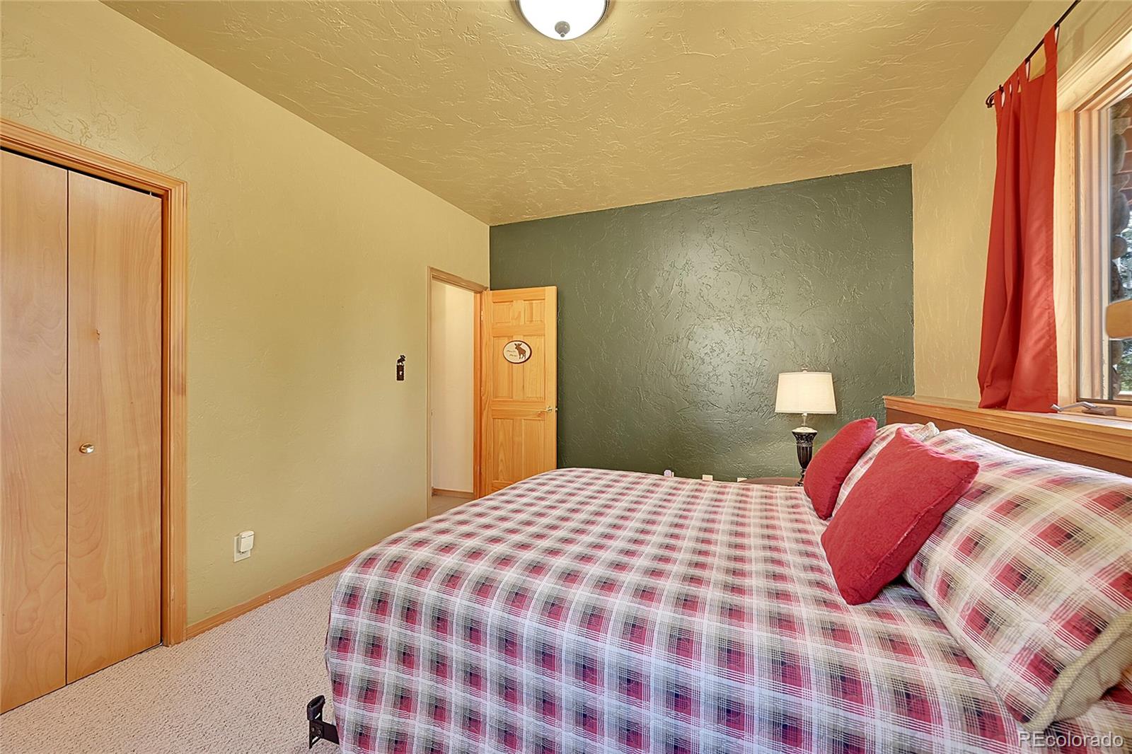 1392 Tapadero Road Bailey, CO 80421 - Photo 26 of 50 a bedroom with a bed and a window