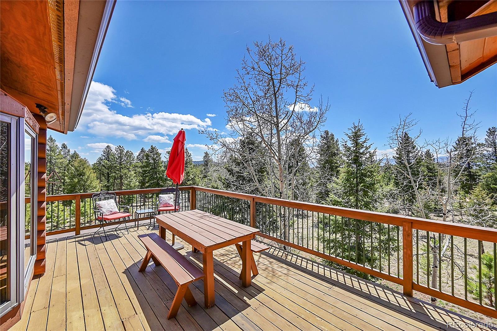 1392 Tapadero Road Bailey, CO 80421 - Photo 31 of 50 a view of balcony with wooden floor and outdoor seating