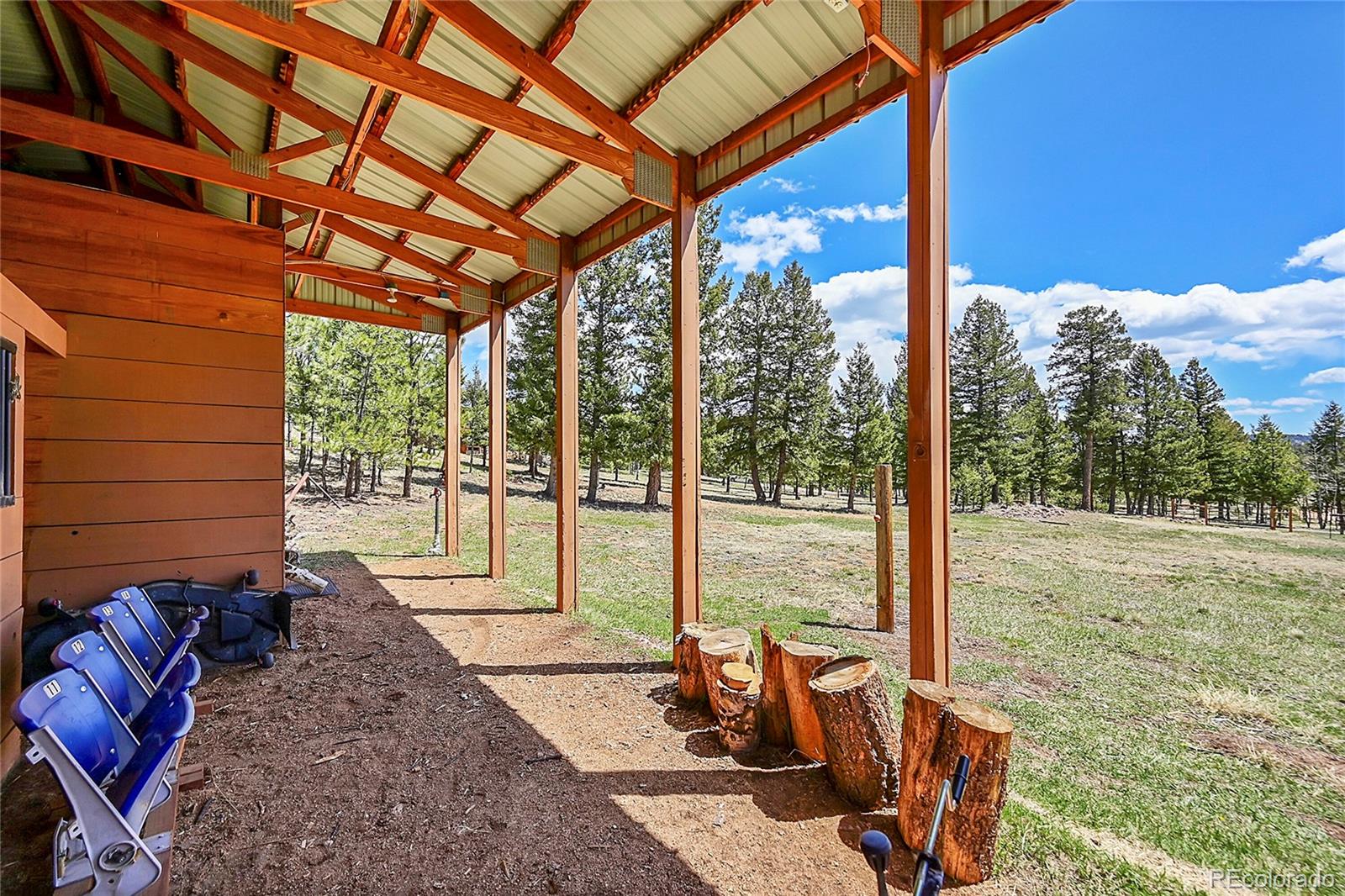1392 Tapadero Road Bailey, CO 80421 - Photo 38 of 50 a view of a porch with furniture and a yard