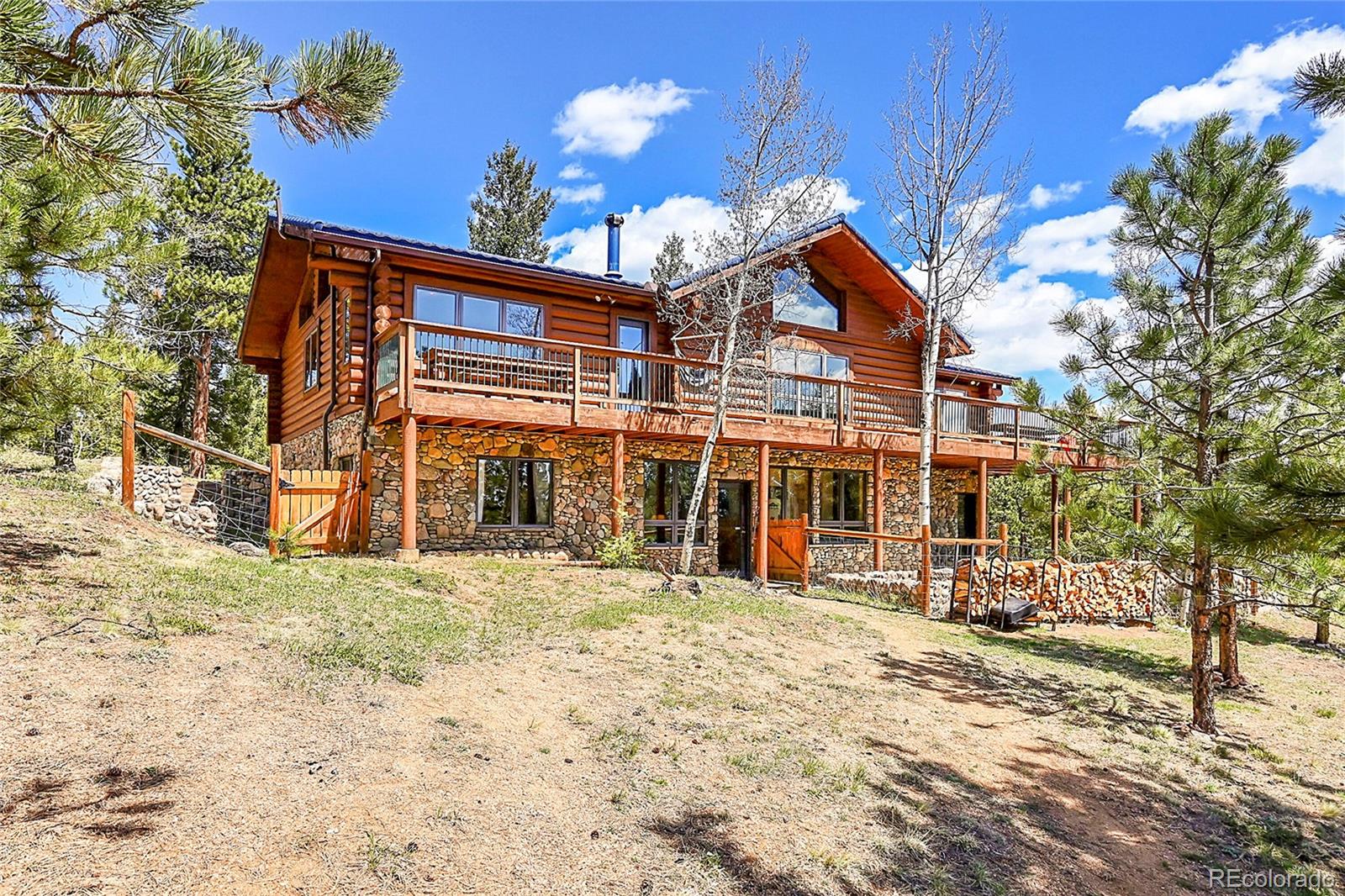 1392 Tapadero Road Bailey, CO 80421 - Photo 44 of 50 a view of a house with a yard