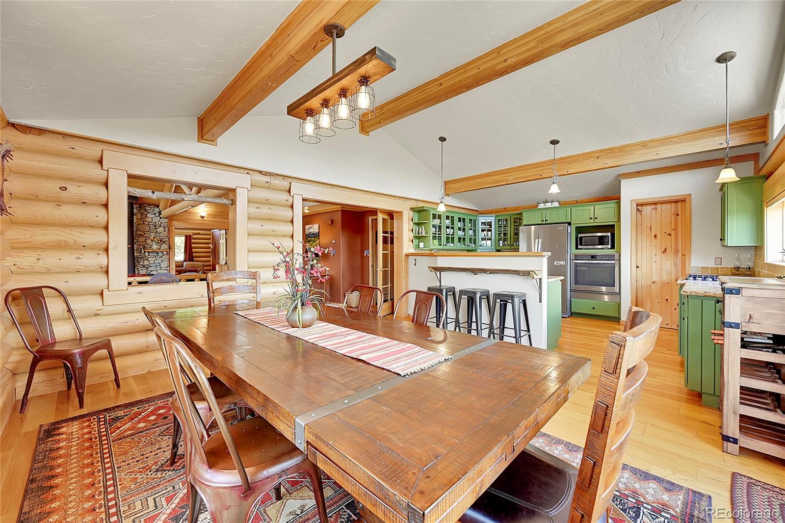 1392 Tapadero Road Bailey, CO 80421 - Photo 10 of 50 a view of a dining room with furniture wooden floor and chandelier