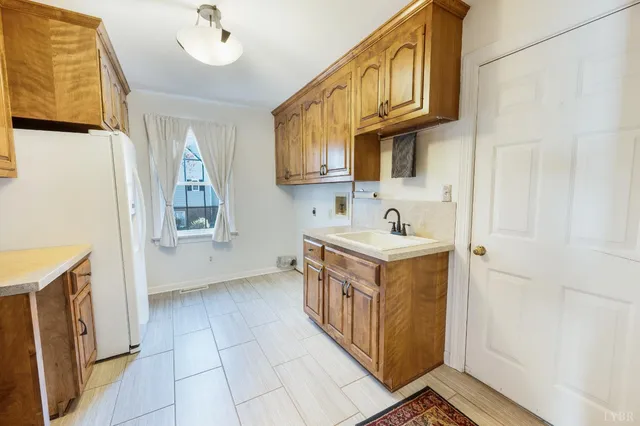 a bathroom with a tub sink vanity and mirror