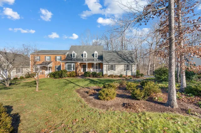 a front view of a house with a yard table and chairs
