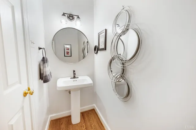 a bathroom with a sink a toilet and mirror
