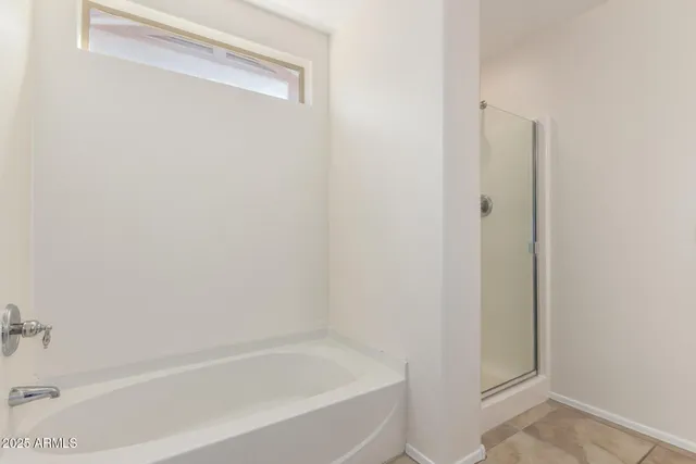 a white bath tub sitting next to a white wooden door