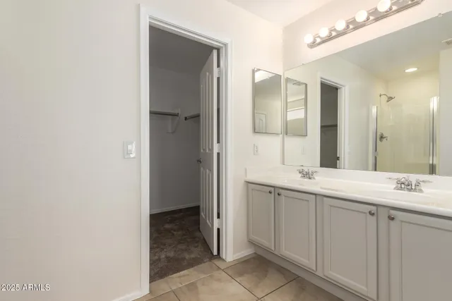 a bathroom with a double vanity sink and a mirror