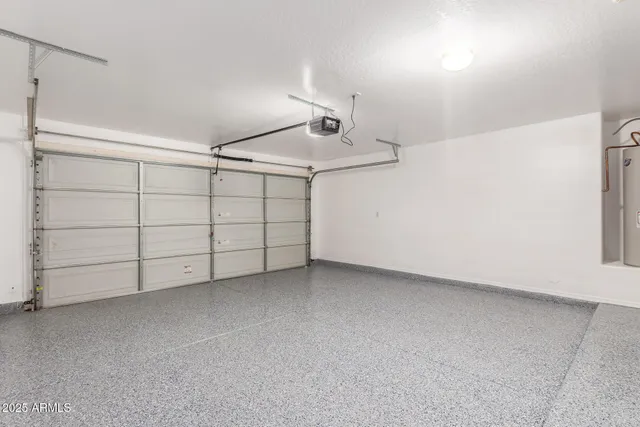 a view of a room with a ceiling fan and window