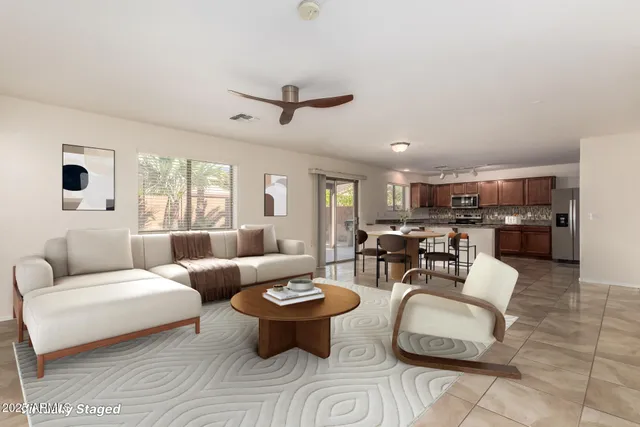 a living room with furniture and view of kitchen