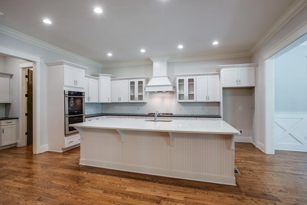 5908 Pinewood Road Franklin, TN 37064 - Photo 11 of 30 a large kitchen with stainless steel appliances granite countertop a large counter top and a stove top oven