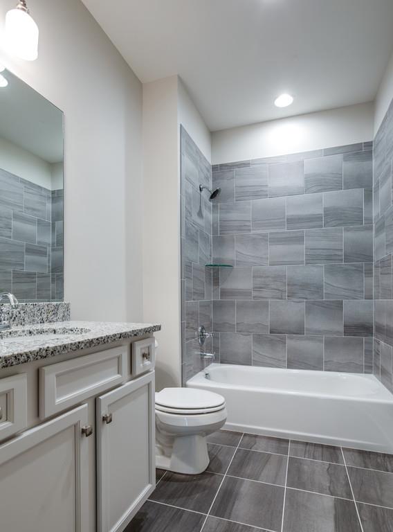 5908 Pinewood Road Franklin, TN 37064 - Photo 23 of 30 a bathroom with a granite countertop bathtub toilet and sink