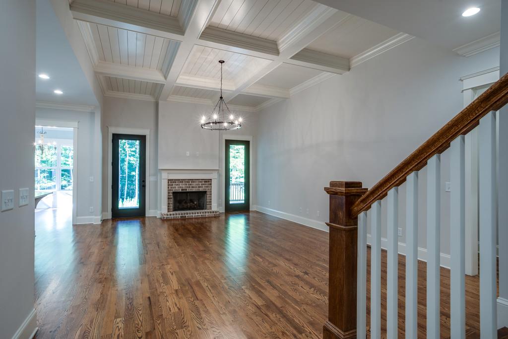 5908 Pinewood Road Franklin, TN 37064 - Photo 7 of 30 a view of an empty room with wooden floor fireplace and a window