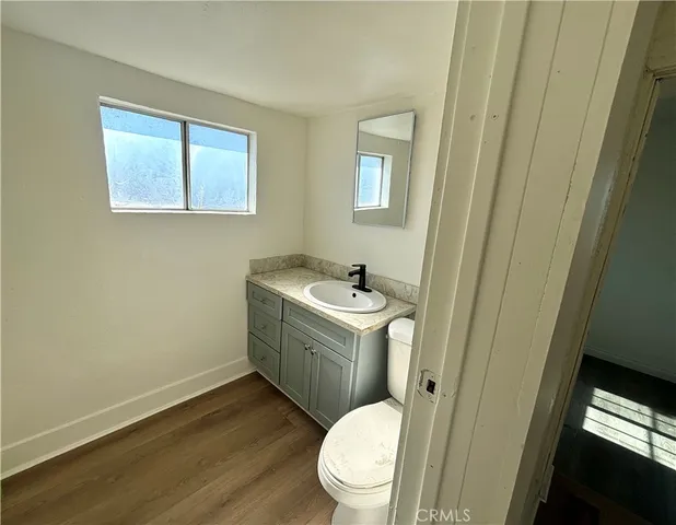 a bathroom with a sink toilet and window