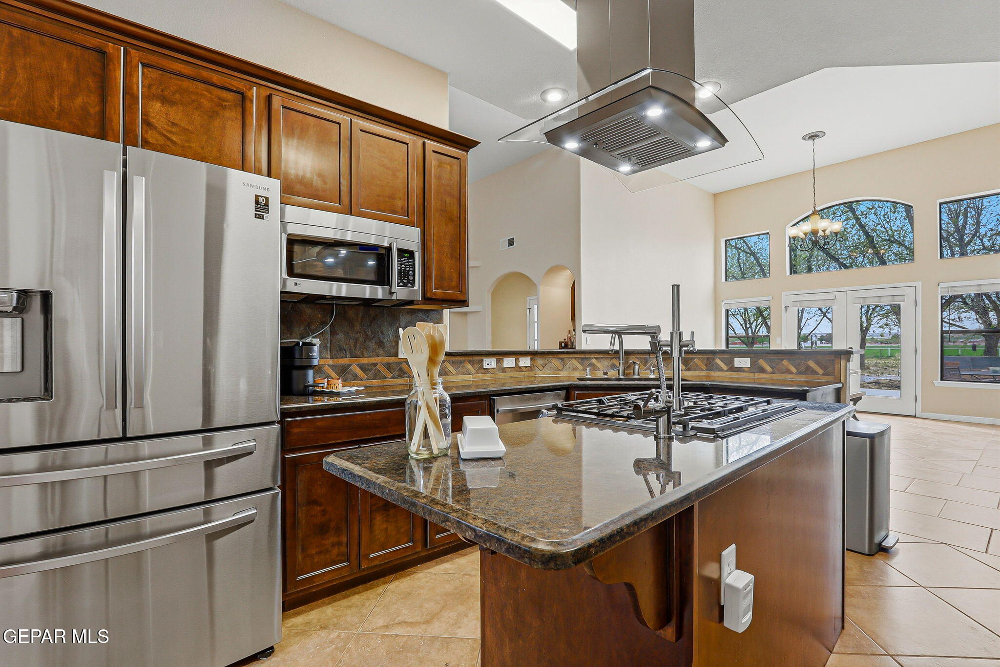 617 Wallace Road Anthony, NM 88021 - Photo 17 of 65 a kitchen with stainless steel appliances granite countertop a sink and a refrigerator