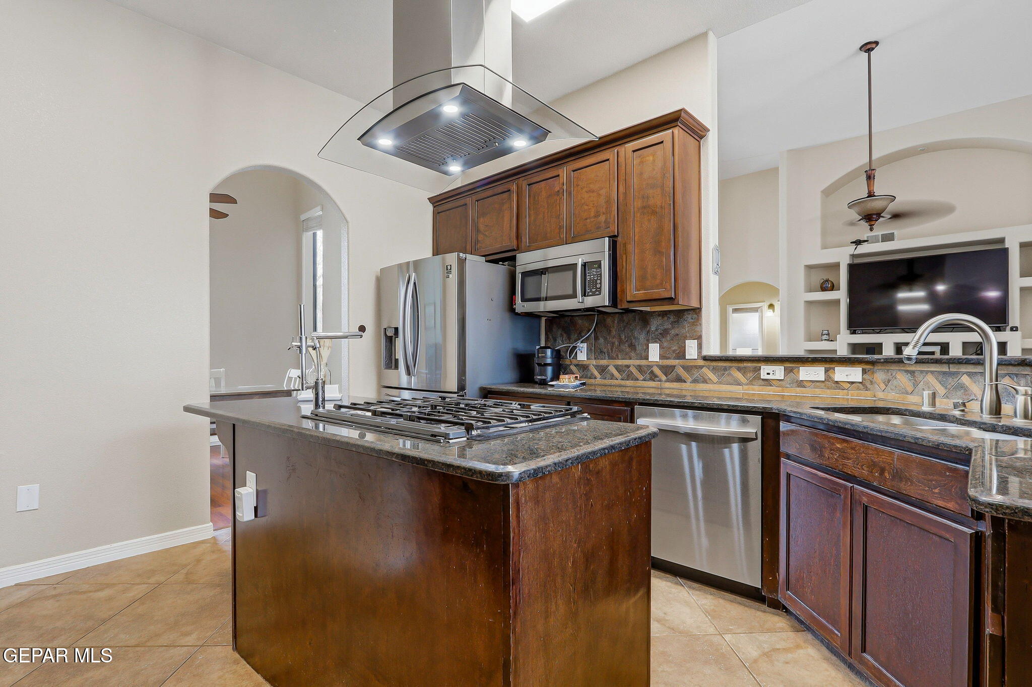 617 Wallace Road Anthony, NM 88021 - Photo 20 of 65 a kitchen with stainless steel appliances granite countertop a sink a stove and cabinets