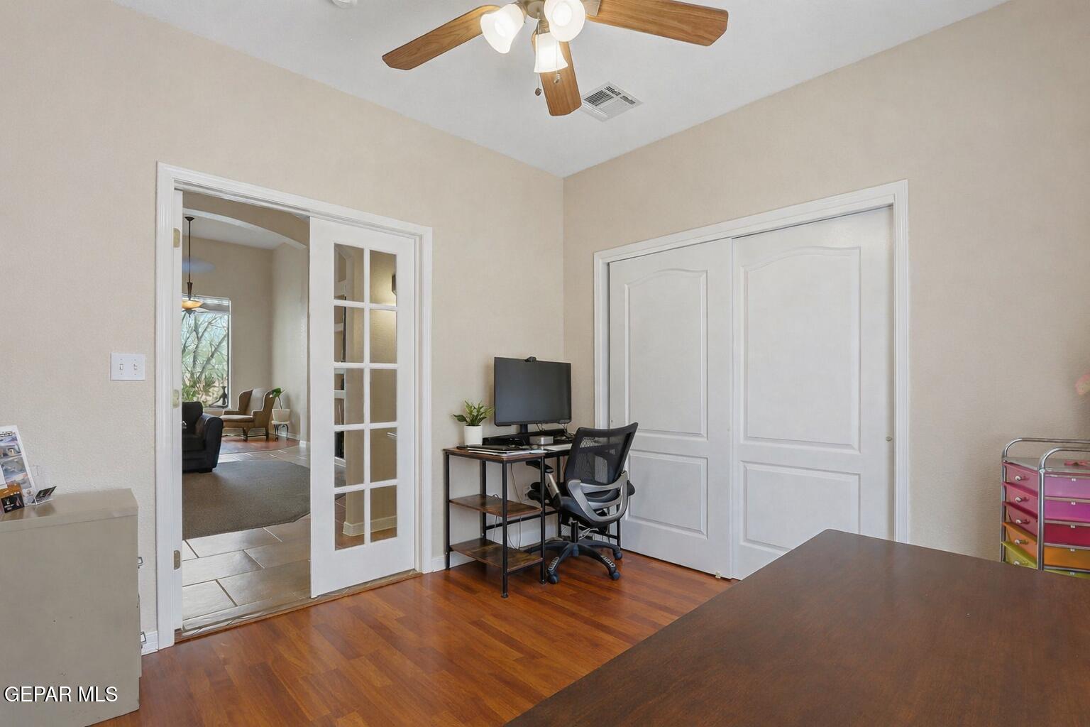 617 Wallace Road Anthony, NM 88021 - Photo 31 of 65 a workspace with wooden floor and a chandelier fan