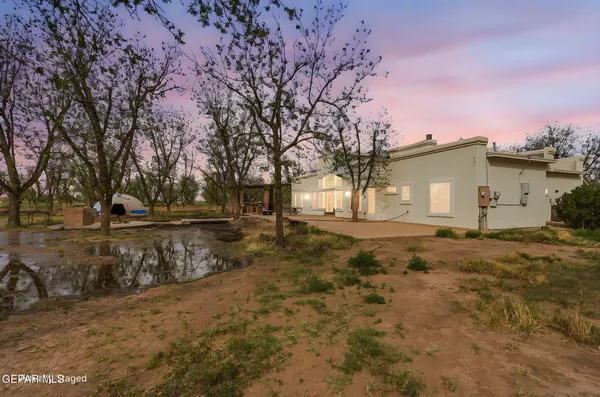 a view of a house with a yard and sitting area