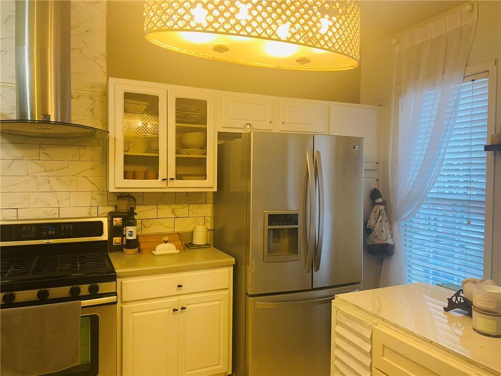 3914 Howell Park Road Duluth, GA 30096 - Photo 9 of 33 a kitchen with a refrigerator and cabinets