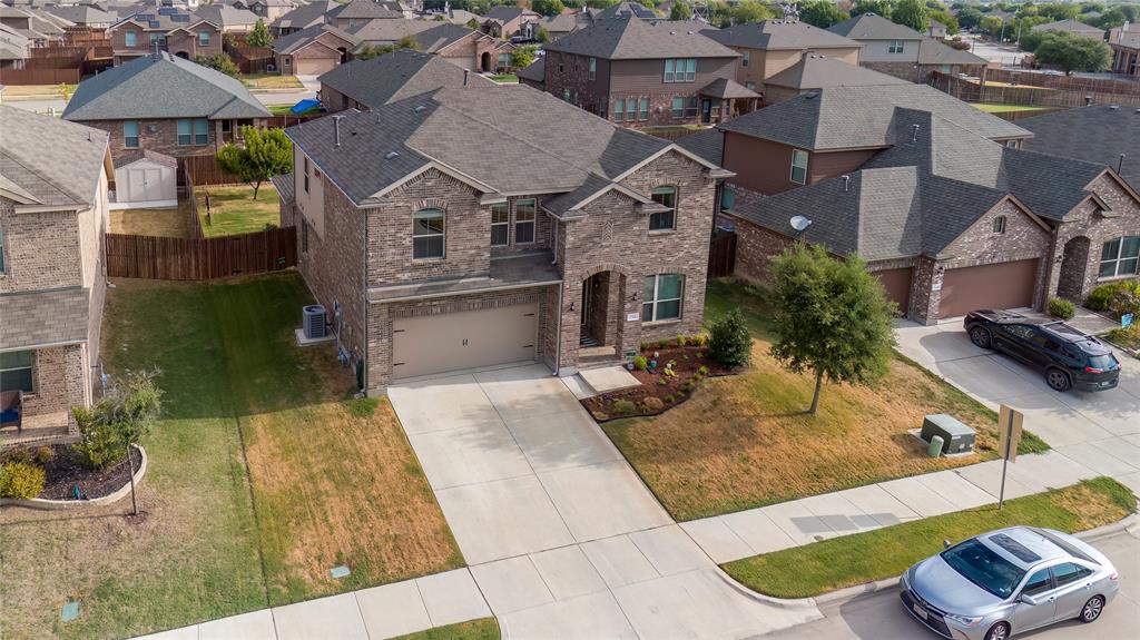 an aerial view of a house with yard and furniture