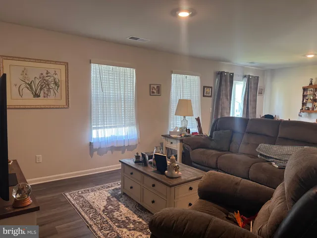 a living room with furniture and windows