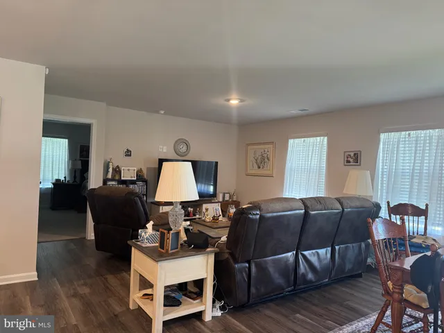 a living room with furniture a wooden floor and a window