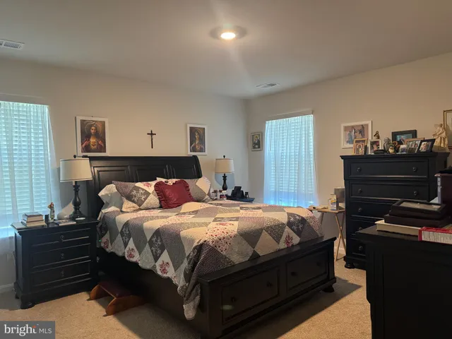 a bedroom with a bed and a dresser