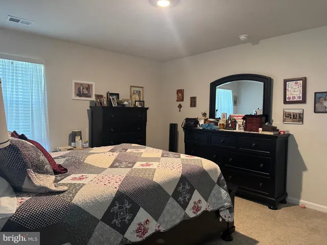 a bedroom with a bed and a dresser