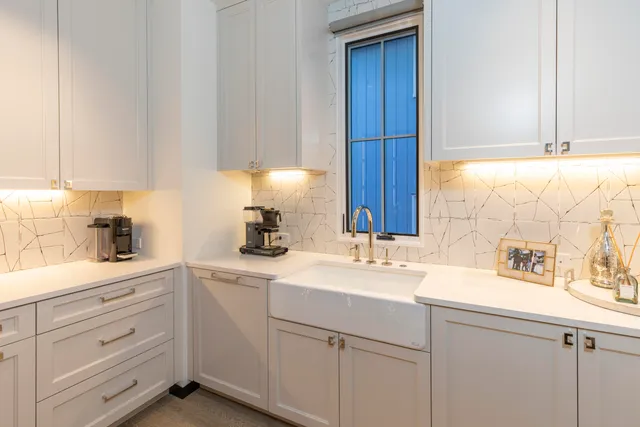 a kitchen with cabinets appliances a sink and a window