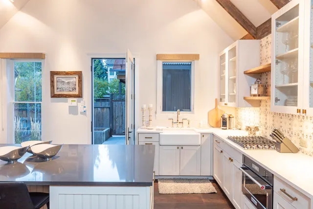 a view of a kitchen with kitchen island a sink appliances cabinets and a counter top space