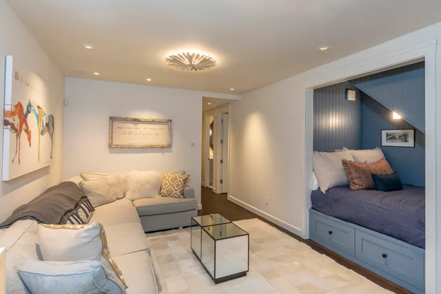 a living room with furniture and a chandelier