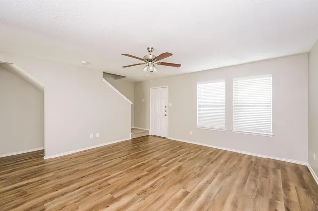 wooden floor in an empty room with a window