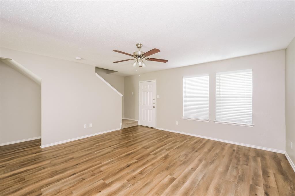 2553 Big Spring Drive Fort Worth, TX 76120 - Photo 2 of 15 wooden floor in an empty room with a window