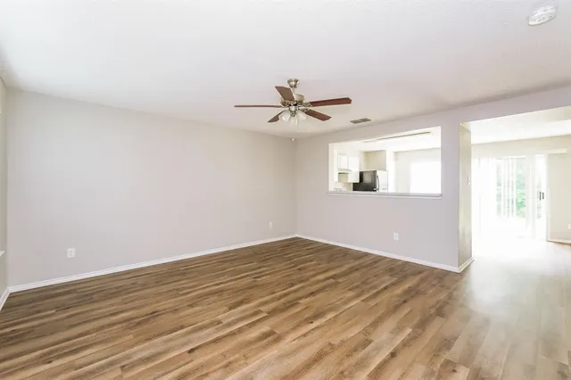 wooden floor in an empty room with a window